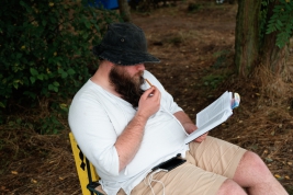 The-men-reading-book-at-the-campsite-of-25th-PolandRock-festival-Kostrzyn-20190801